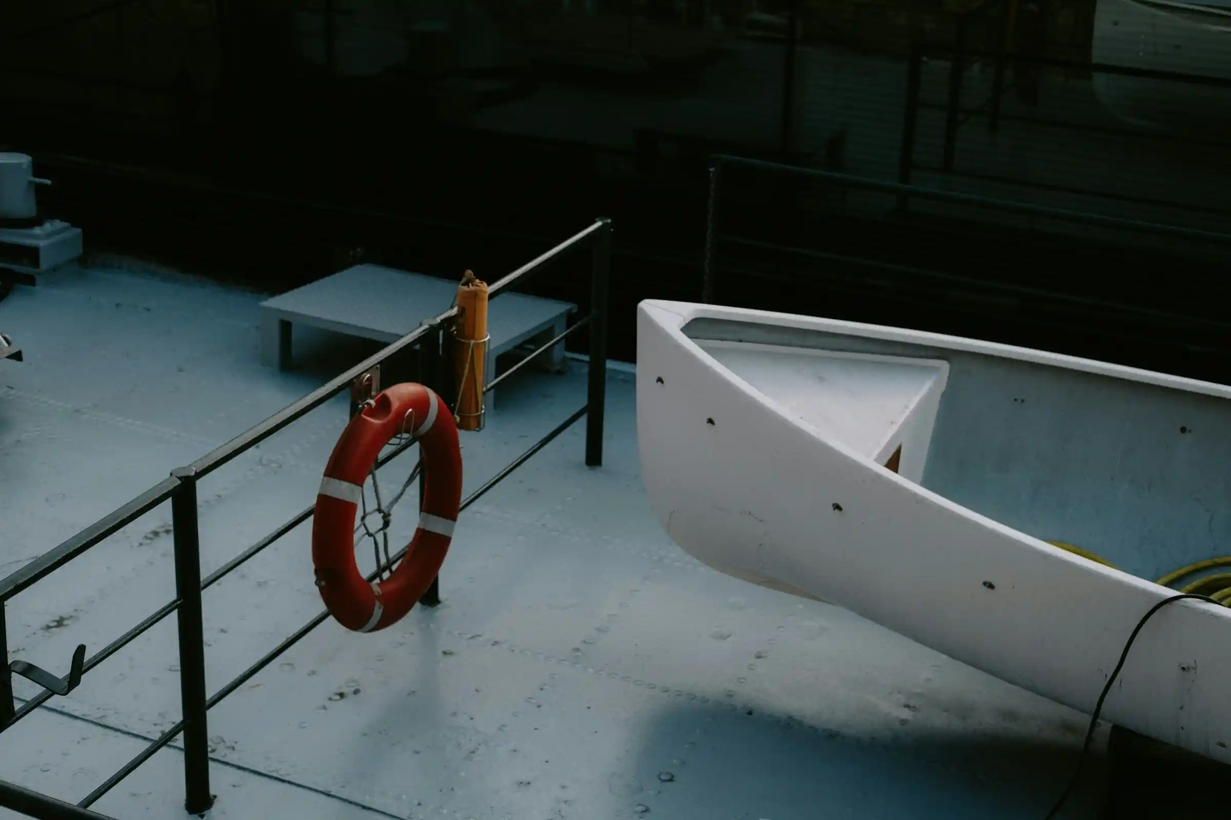 A lifebuoy and a lifeboat on the deck of a boat, essential equipment for houseboats safety.