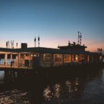 Traditional wooden houseboat docked on calm water, symbolizing durability, craftsmanship, and houseboat longevity.
