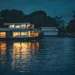 A modern two-story houseboat size shown on calm waters, highlighting space and design for comfortable living and cruising.